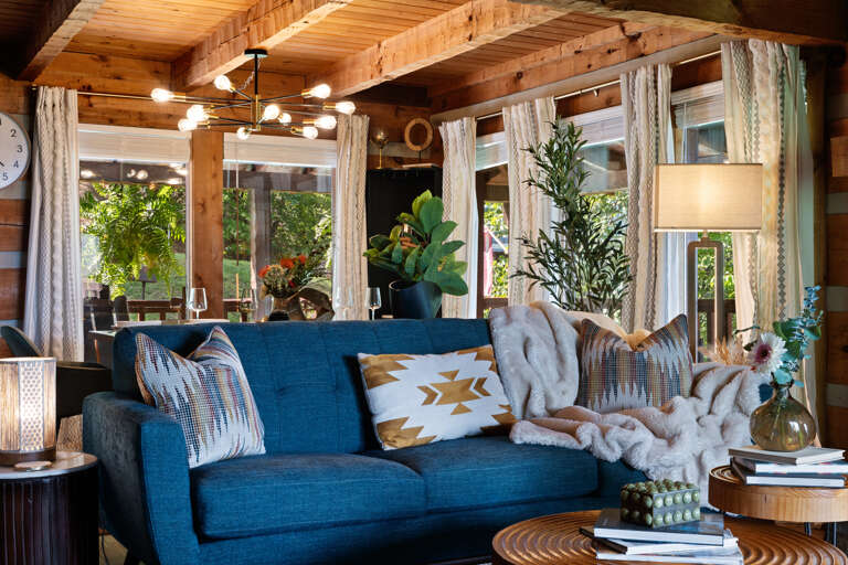 Sink into the plush blue sofa and let the mountain quiet take over — pure relaxation awaits in the living room at Dancing Embers.