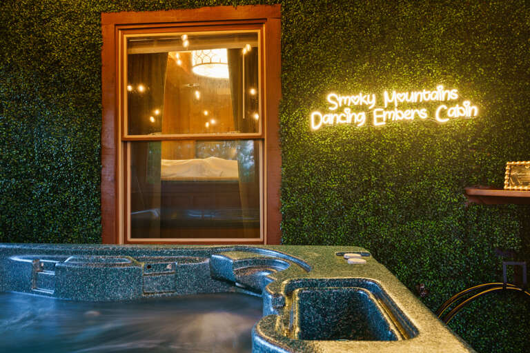 Bubbles, string lights, and the glow of the Dancing Embers sign — this private hot tub is made for unforgettable mountain nights.