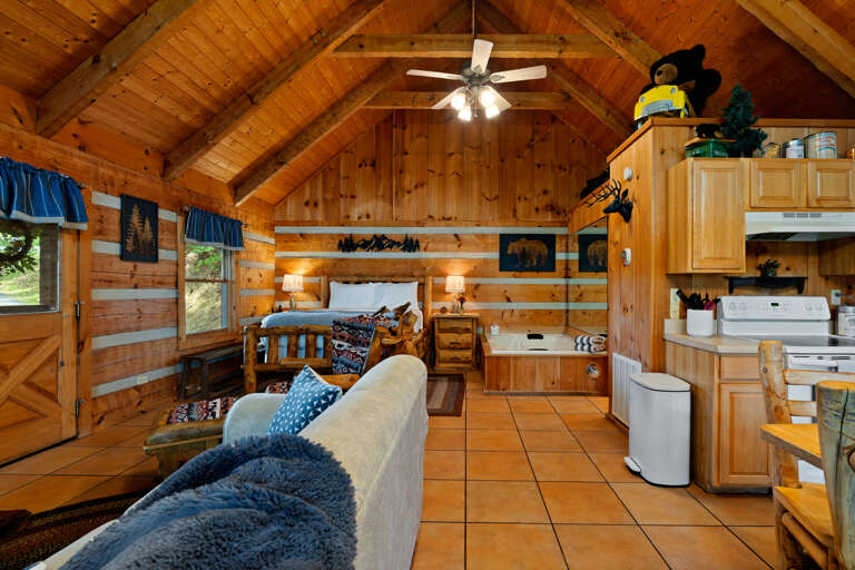 Vaulted wood ceilings and an open layout give the kitchen at Nestled Oaks warm, rustic cabin charm for easy togetherness.