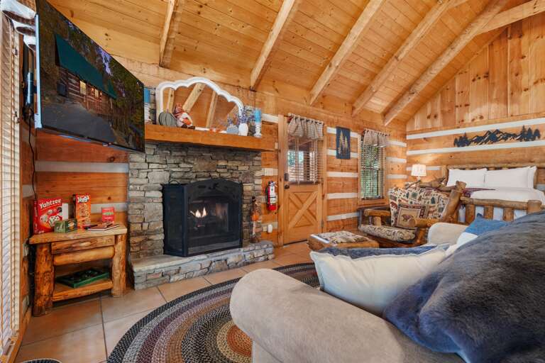 Cozy up by the stone fireplace — rustic comfort and cabin charm meet ultimate relaxation.