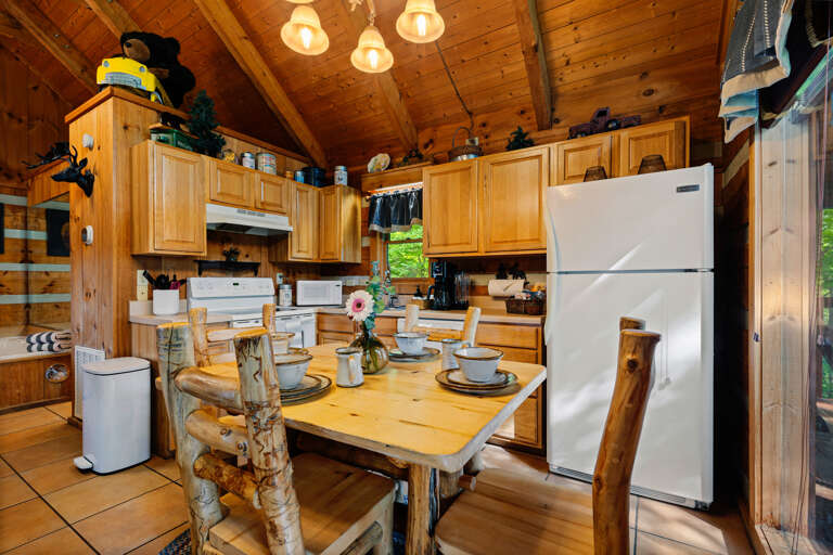 Cook, dine, and relax in this cozy, fully equipped kitchen at Nestled Oaks, made for easy mountain getaways.