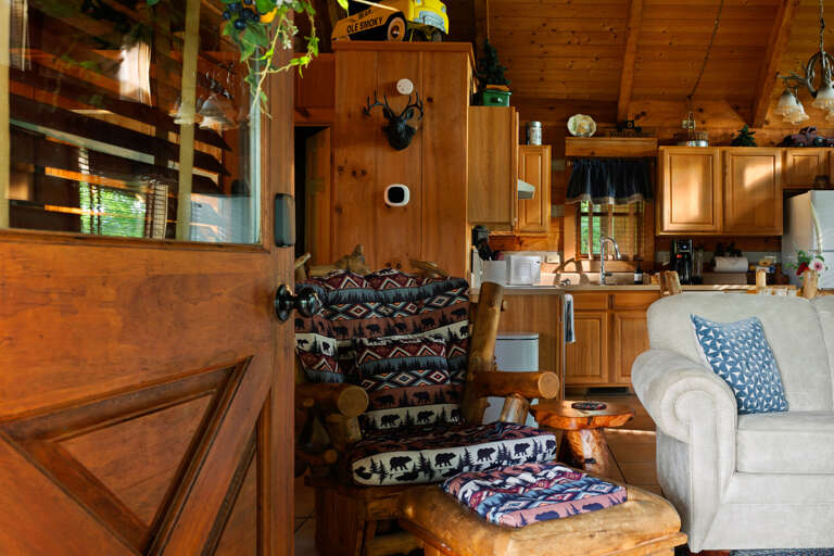 Warm log walls and rustic charm welcome you into the heart of Nestled Oaks, ready for cozy mornings and easy evenings.