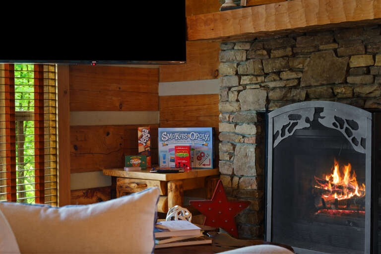 Curl up by the crackling fireplace — the living room at Nestled Oaks is made for cozy nights in the mountains.