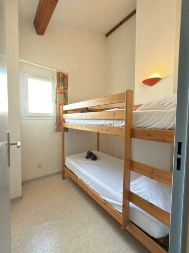 Bunk Beds Basking Beneath Beams