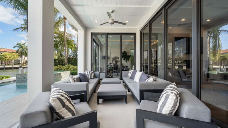 Spacious Patio With Plush Seating And Poolside View