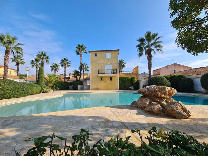 Palm-fringed Pool, Yellow Building, Blue Sky