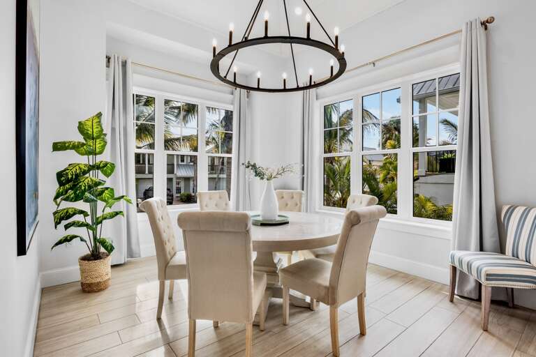 Dining nook with large windows and tropical views