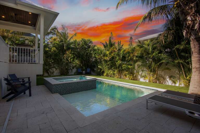 Stunning sunset views with private pool and spa surrounded by lush palms