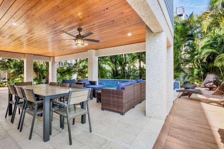 Private covered patio with dining space and spa