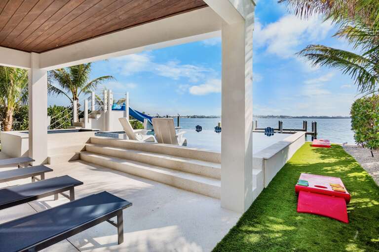 Sun Loungers with Pool Views and Cornhole