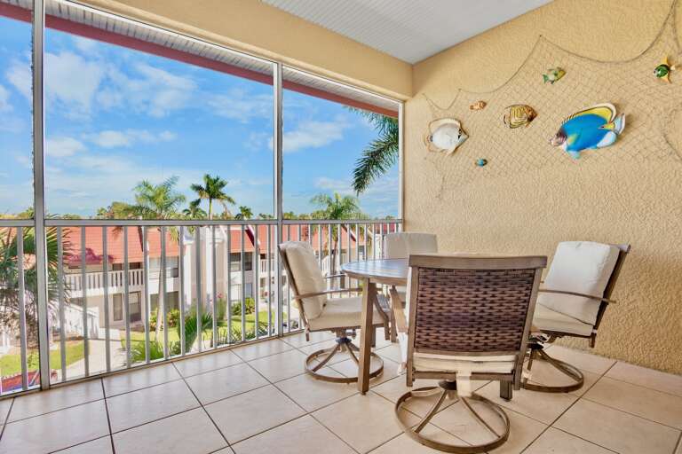 Screened-in balcony with lounge chairs