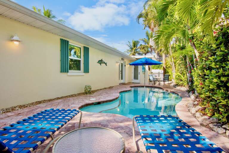 Relax by your private pool surrounded by tropical palms and colorful lounge chairs, with convenient patio dining just steps away from the sparkling water.