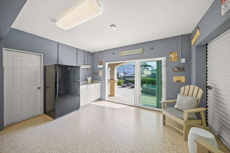 Private garage features kitchenette, seating area, and direct pool access