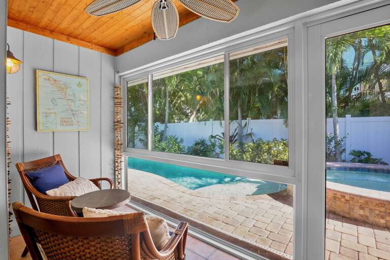 Primary Bedroom with seating and stunning pool views