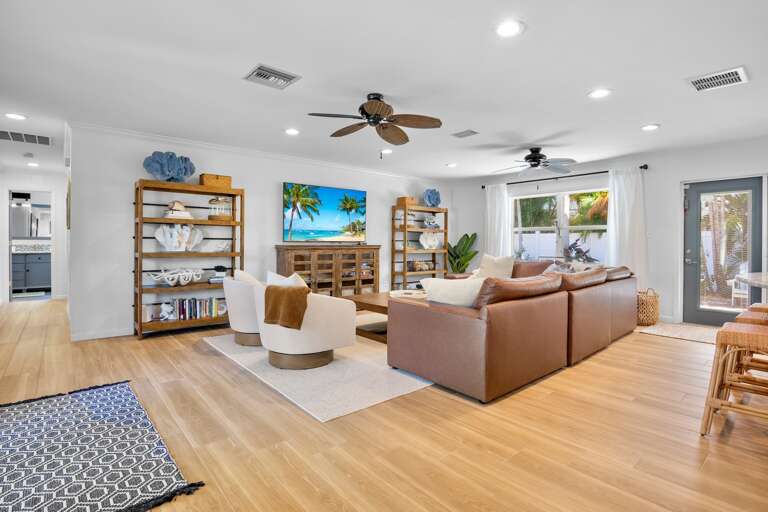 Spacious living area with plush leather seating with TV