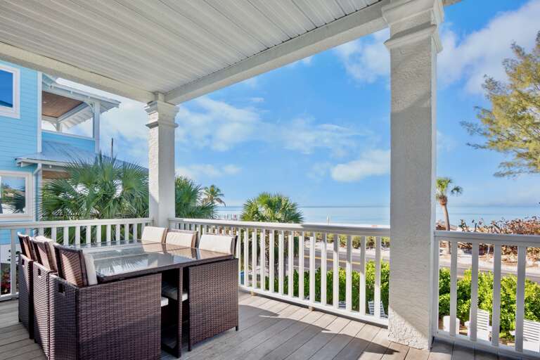 Private covered porch with comfortable dining area