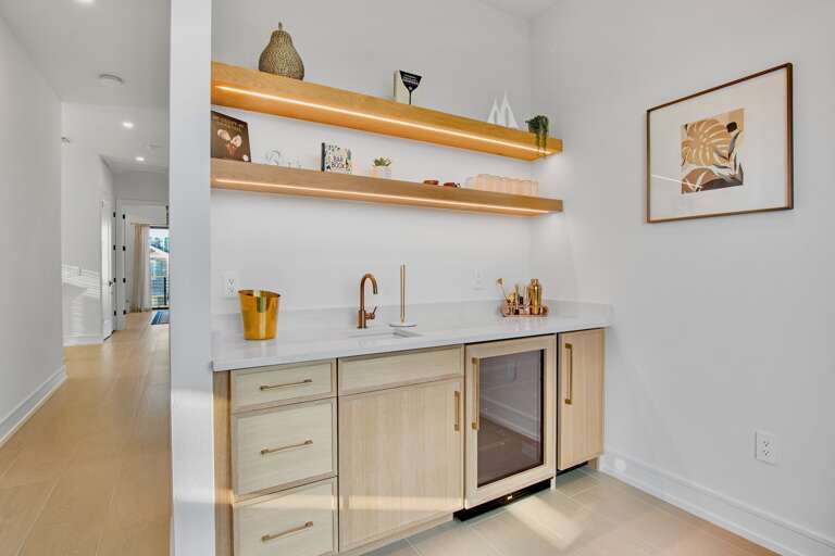 Wet bar with wood cabinets and countertops