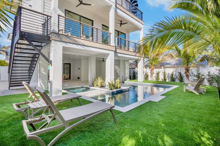 Modern property featuring a stunning swimming pool surrounded by tropical landscaping and contemporary architecture.