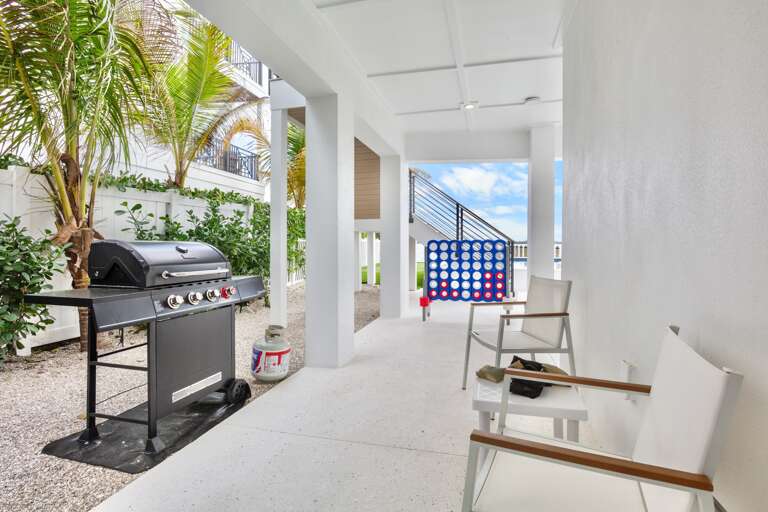 Covered outdoor space with games and BBQ grill