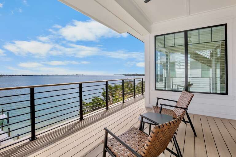 Unwind on your private waterfront balcony with comfortable seating and breathtaking ocean views stretching to the horizon.