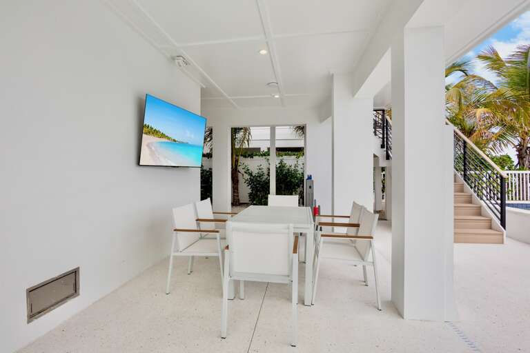 Covered outdoor dining table with TV