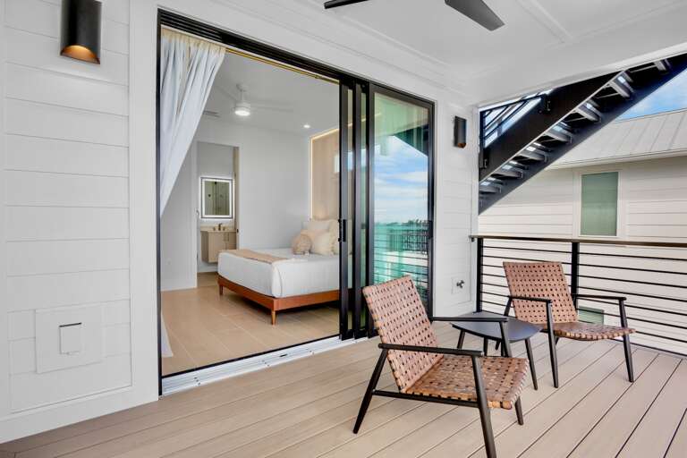 Seamlessly blend indoor comfort with outdoor serenity on your private balcony, where modern furnishings meet stunning water views.