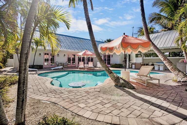 Private tropical oasis and pool surrounded by swaying palms