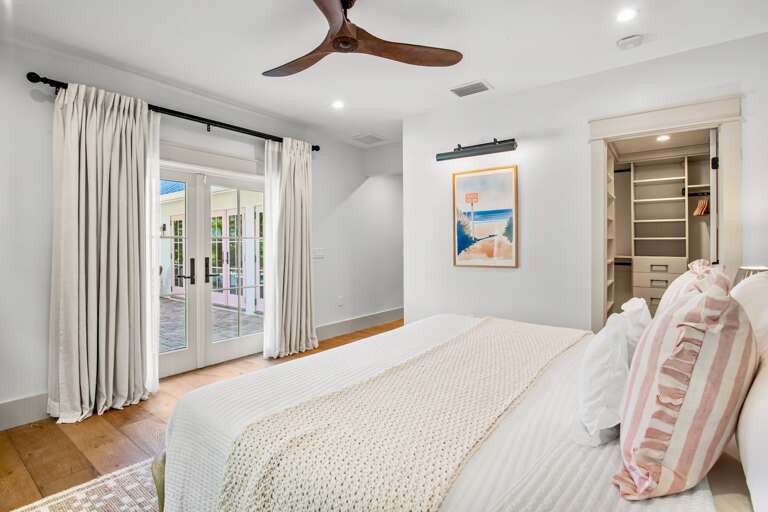Primary bedroom with pool access and closet, King bed