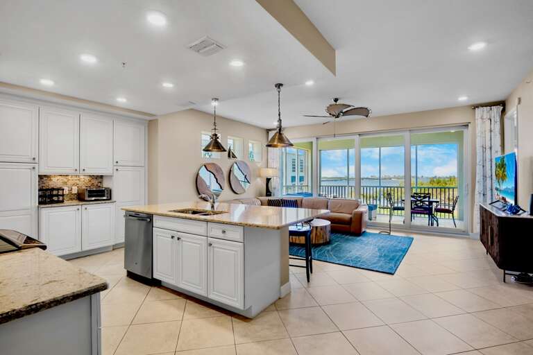 Open-concept living area with kitchen island and screened lanai