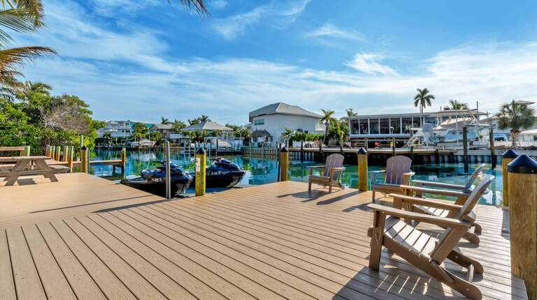 Private waterfront deck with Adirondack chairs