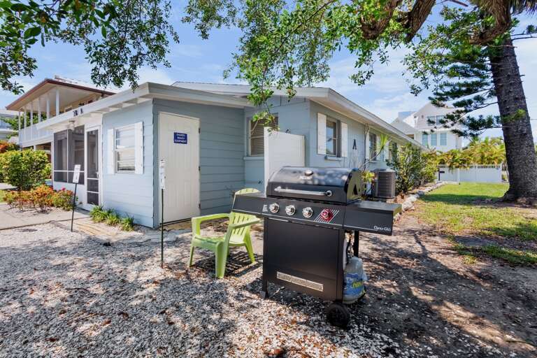 Exterior view of the property with outdoor grill area.