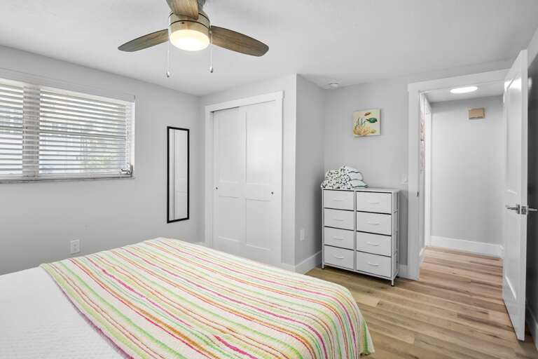 Primary bedroom with king bed and plenty clothing storage.