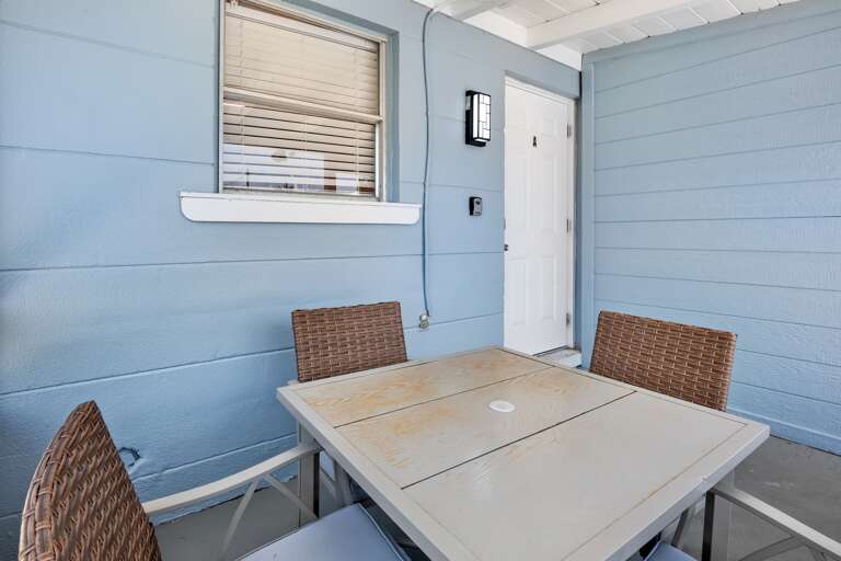 Screened-in lanai with outdoor dining table.