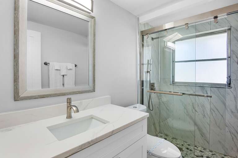 Updated bathroom with modern finishes and walk-in shower.