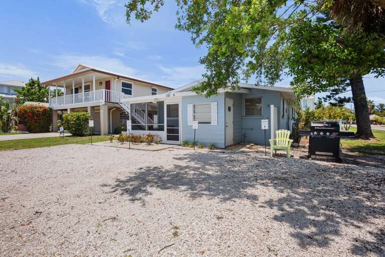 Exterior view of the home with screened lanai and dedicated parking.