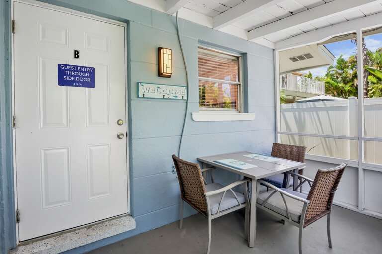 Screened-in lanai with outdoor dining table.