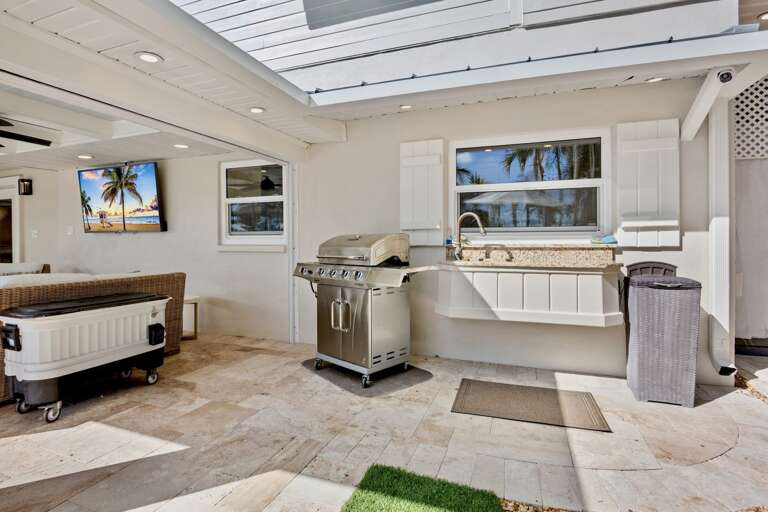 Outdoor kitchen with grill and granite counters