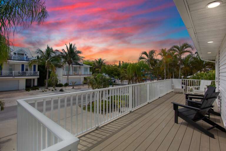 Outdoor deck with Adirondack seating and tropical views