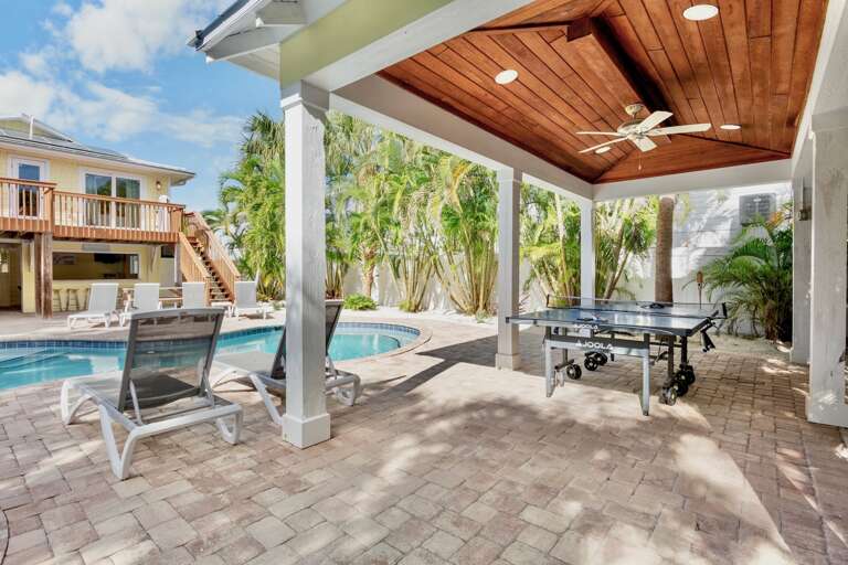 Private covered patio with ping-pong table