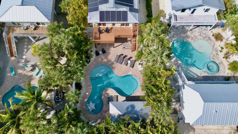 Tropical home featuring a private pool