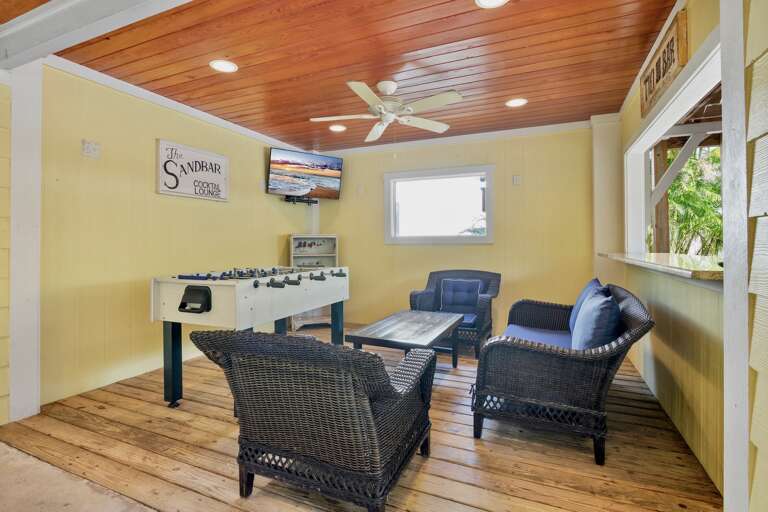 Private game room featuring comfortable seating, foosball table, and TV.