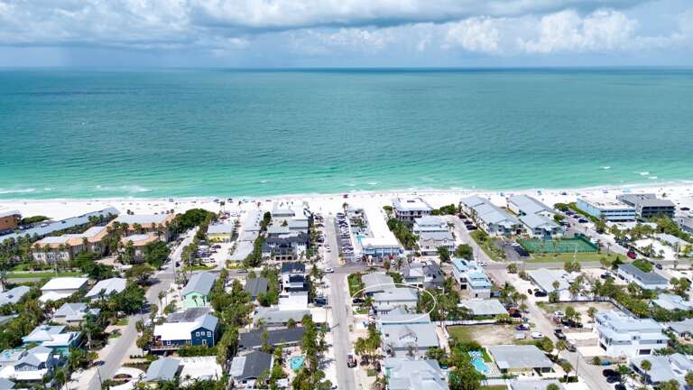 Aerial view showcasing home and beach