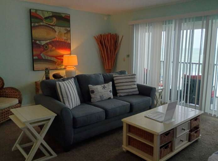 Living room with balcony and beach view