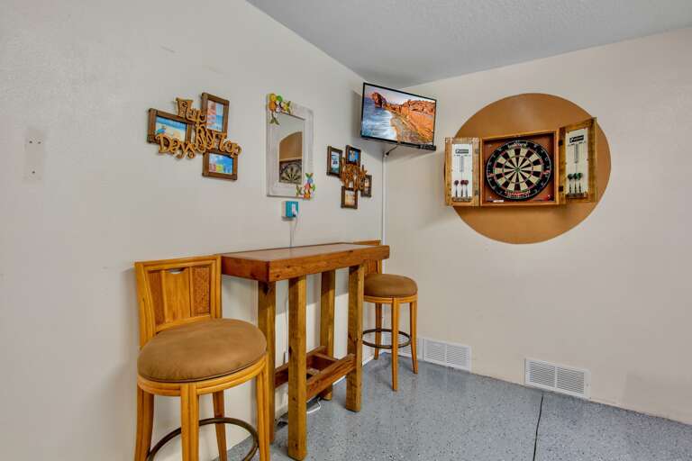 Game room with a dartboard and high-top seating