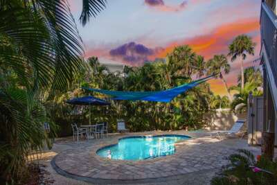 Private pool with shade sail and outdoor dining