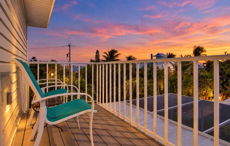 Private balcony with chairs at sunset