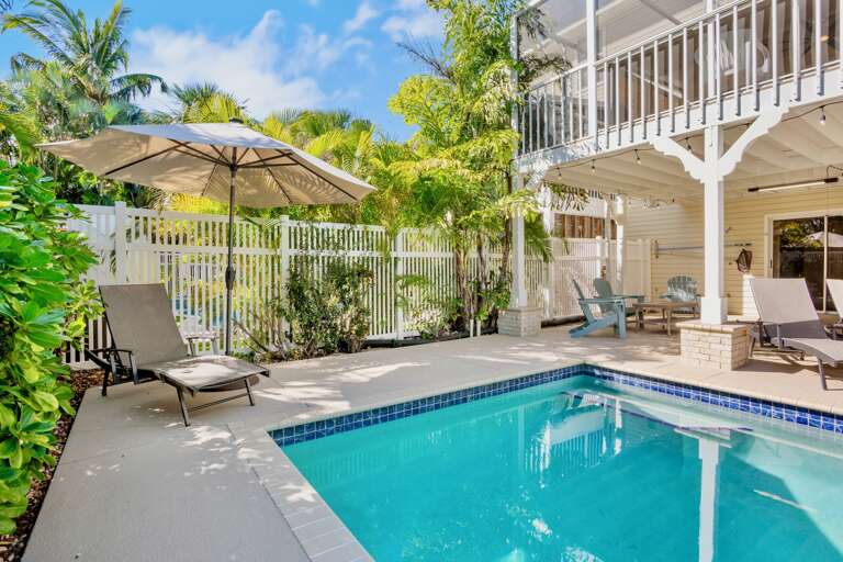 Private pool oasis surrounded by lush tropical palms