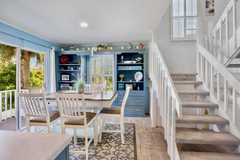 Dining space opens to tropical views, with built-in storage