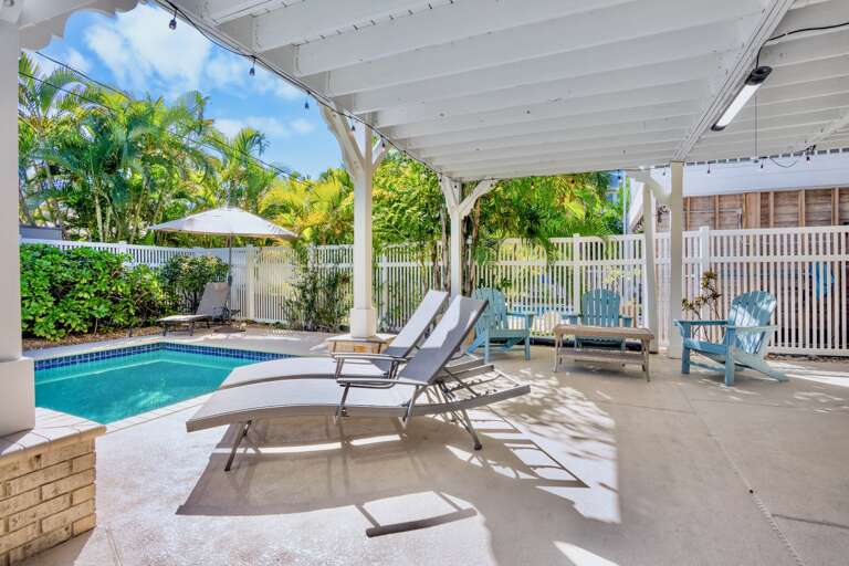 Private covered patio with pool loungers
