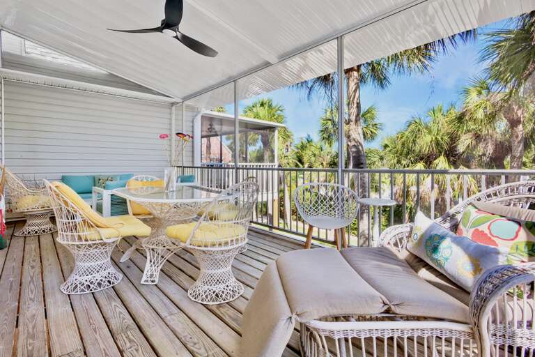 Coastal lanai with dining table and lounge area
